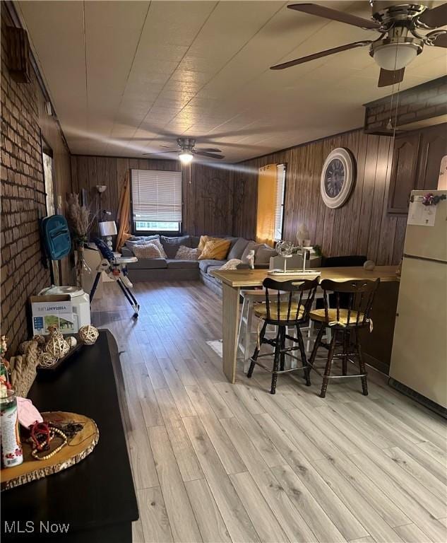 202 Grant St, Newell, WV 26050 - living area with wooden walls, ceiling fan, light wood finished floors, and brick wall