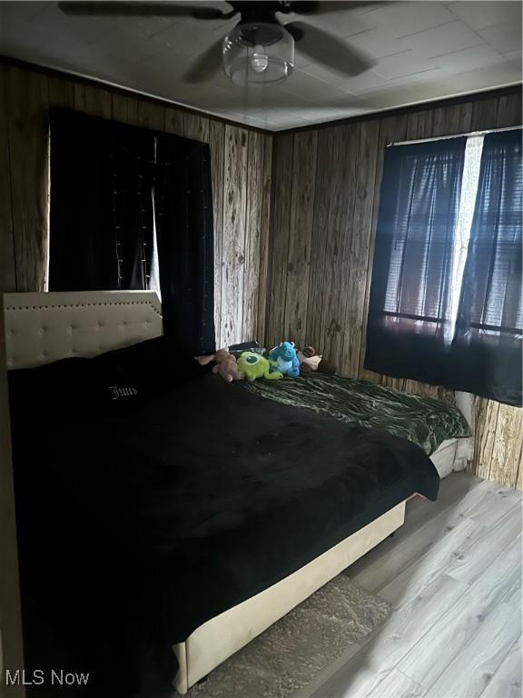 202 Grant St, Newell, WV 26050 - bedroom with wooden walls, ceiling fan, and wood finished floors