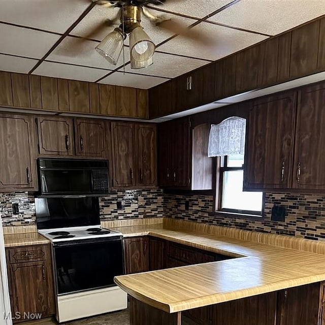 202 Grant St, Newell, WV 26050 - kitchen with black microwave, electric stove, dark brown cabinets, and decorative backsplash