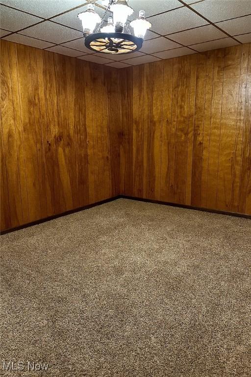 202 Grant St, Newell, WV 26050 - unfurnished room featuring wooden walls, a paneled ceiling, and a chandelier