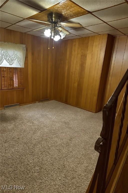 202 Grant St, Newell, WV 26050 - carpeted empty room with a ceiling fan, a paneled ceiling, and wooden walls