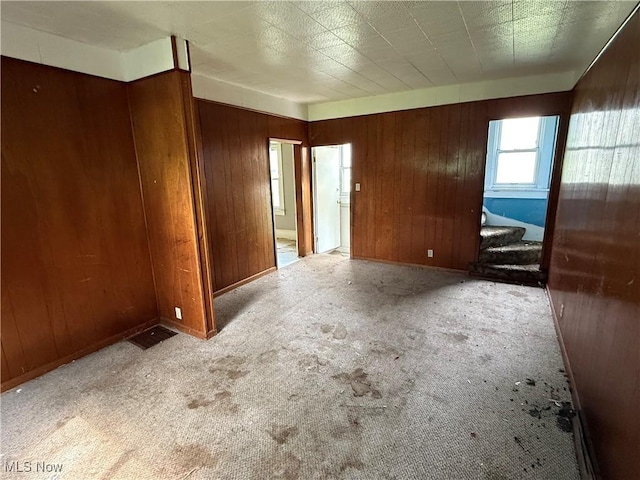 2013 7th St NE, Canton, OH 44704 - carpeted empty room with wooden walls