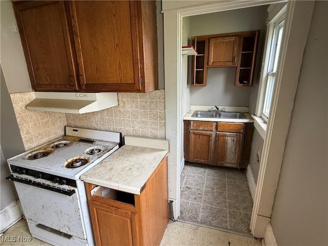 2013 7th St NE, Canton, OH 44704 - kitchen with electric range, under cabinet range hood, light countertops, and tasteful backsplash