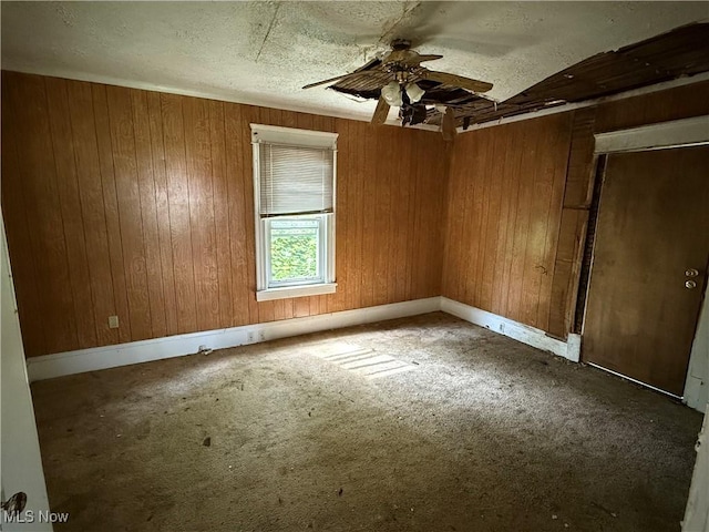2013 7th St NE, Canton, OH 44704 - carpeted empty room with ceiling fan and wood walls