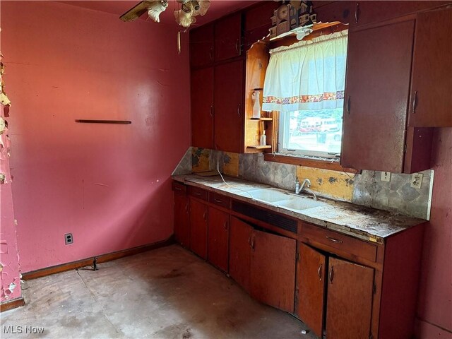 2013 7th St NE, Canton, OH 44704 - kitchen with backsplash, unfinished concrete flooring, and ceiling fan