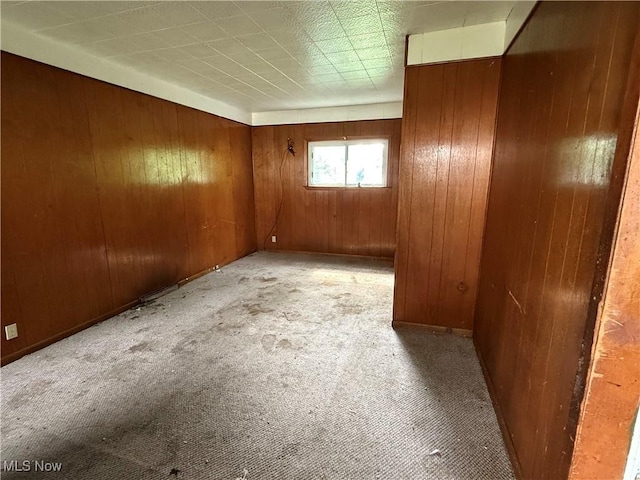 2013 7th St NE, Canton, OH 44704 - spare room featuring wooden walls and light carpet