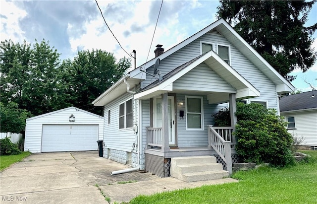 1104 Kenmore Ave SE, Warren, OH 44484 - view of front of property featuring a detached garage, an outbuilding, a chimney, and a porch