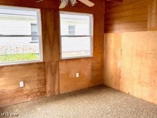 1104 Kenmore Ave SE, Warren, OH 44484 - empty room featuring wooden walls and a ceiling fan