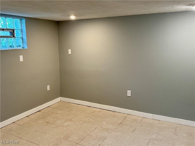 1104 Kenmore Ave SE, Warren, OH 44484 - spare room with a textured ceiling and baseboards