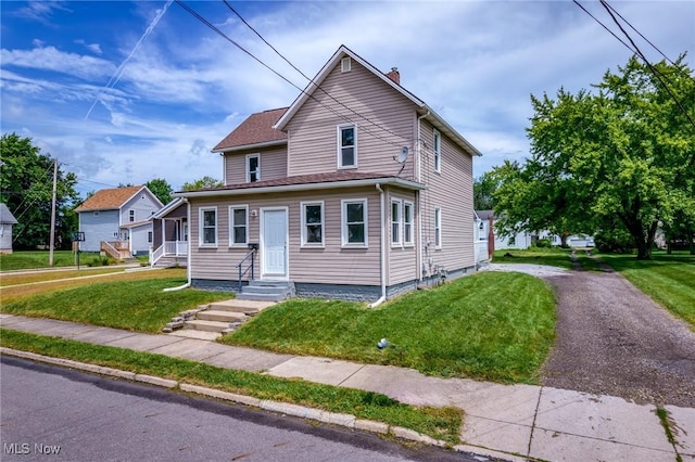 1014 Noble St E, Alliance, OH 44601 - view of front of property featuring a chimney and a front lawn