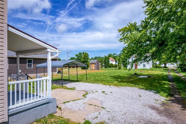 1014 Noble St E, Alliance, OH 44601 - view of grassy yard featuring a detached carport, driveway, and a storage shed