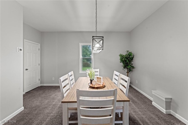 1014 Noble St E, Alliance, OH 44601 - carpeted dining area with baseboards and a chandelier