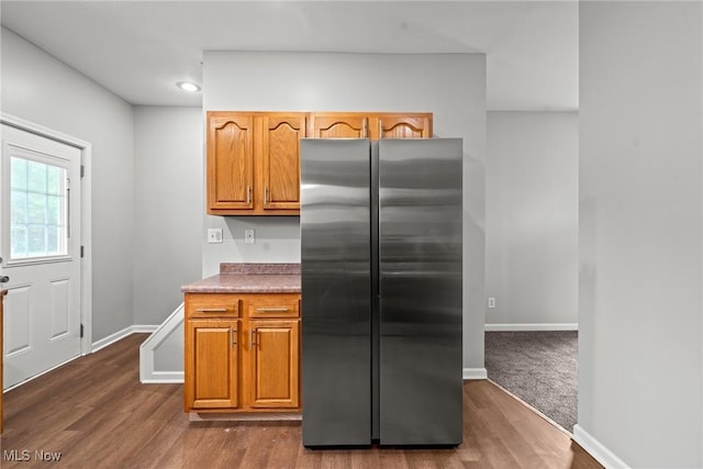 1014 Noble St E, Alliance, OH 44601 - kitchen with freestanding refrigerator, dark wood finished floors, recessed lighting, and brown cabinets