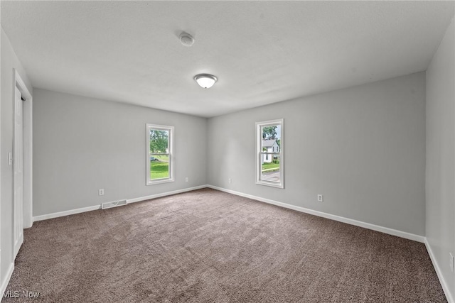 1014 Noble St E, Alliance, OH 44601 - carpeted spare room featuring plenty of natural light and a smoke detector