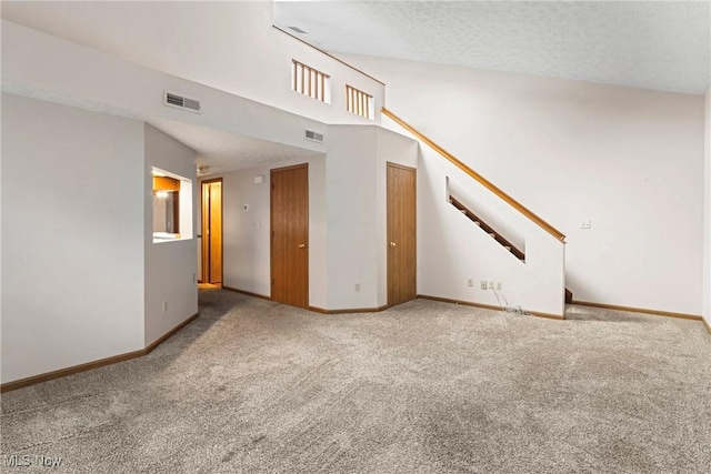 3494 Ivy Hill Cir Unit A, Cortland, OH 44410 - unfurnished living room featuring carpet, stairs, and a textured ceiling
