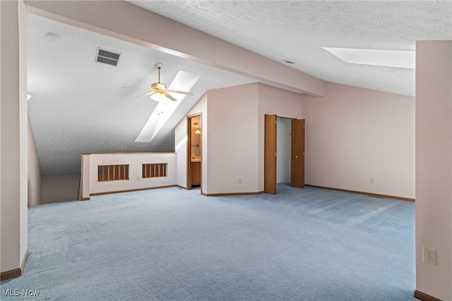 3494 Ivy Hill Cir Unit A, Cortland, OH 44410 - additional living space featuring a skylight, lofted ceiling, carpet floors, a textured ceiling, and ceiling fan