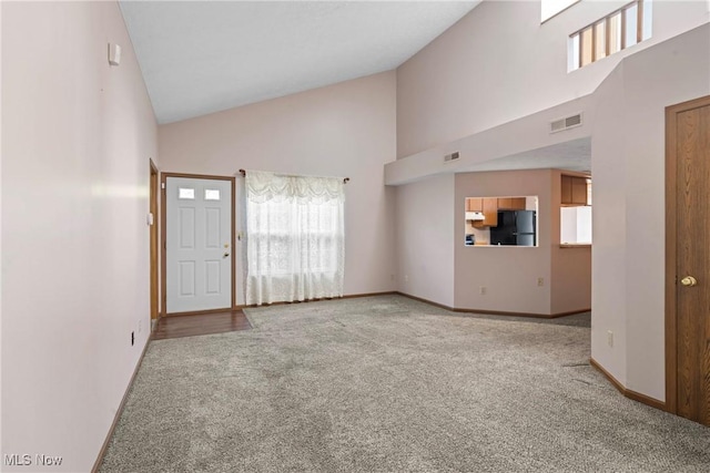 3494 Ivy Hill Cir Unit A, Cortland, OH 44410 - unfurnished living room with high vaulted ceiling and carpet flooring
