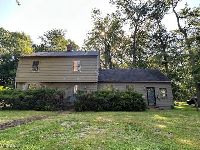 175 Curtis Dr, Avon Lake, OH 44012 - back of house with a lawn and a chimney