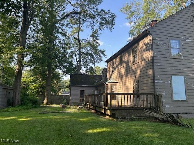 175 Curtis Dr, Avon Lake, OH 44012 - view of side of home with a yard, a deck, and a chimney