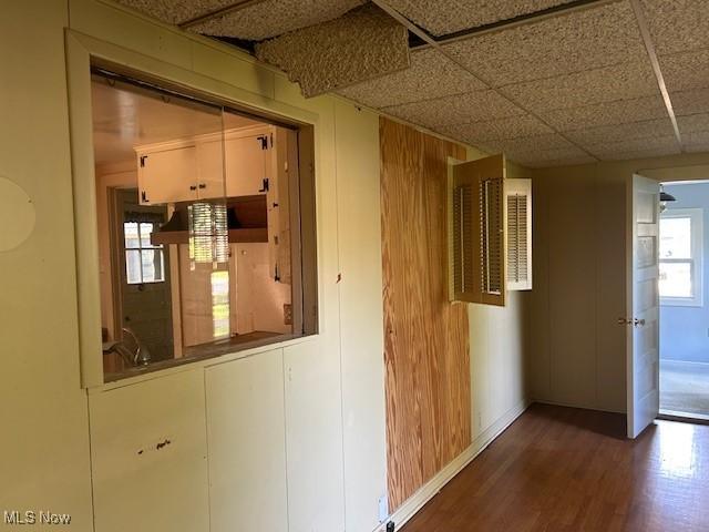 175 Curtis Dr, Avon Lake, OH 44012 - hallway with wood finished floors, plenty of natural light, a drop ceiling, and wooden walls