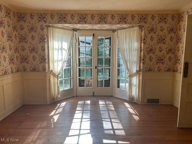 175 Curtis Dr, Avon Lake, OH 44012 - doorway featuring wallpapered walls, plenty of natural light, a wainscoted wall, wood finished floors, and a decorative wall