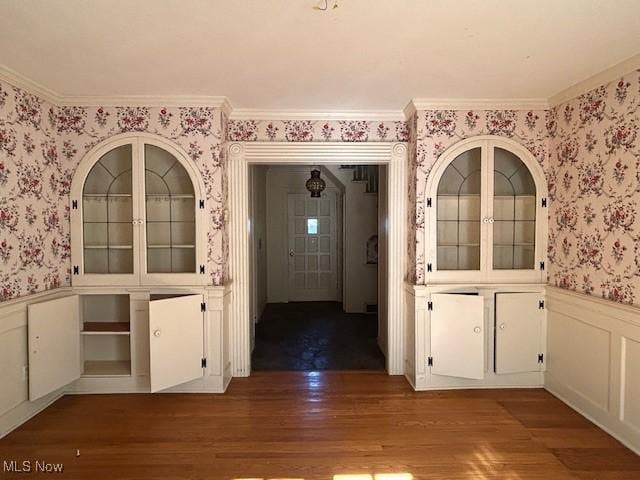 175 Curtis Dr, Avon Lake, OH 44012 - unfurnished dining area with wallpapered walls, wainscoting, wood finished floors, and crown molding