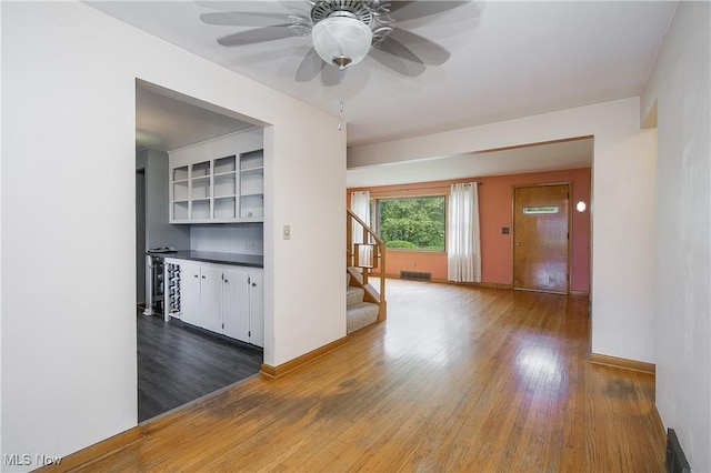 8298 Walter St NW, Massillon, OH 44646 - spare room with stairs, wood finished floors, and ceiling fan