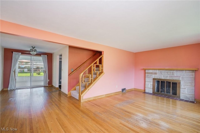 8298 Walter St NW, Massillon, OH 44646 - unfurnished living room with wood finished floors, stairway, and a fireplace