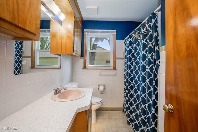 8298 Walter St NW, Massillon, OH 44646 - full bath featuring tile walls, plenty of natural light, vanity, tile patterned flooring, and a shower with shower curtain