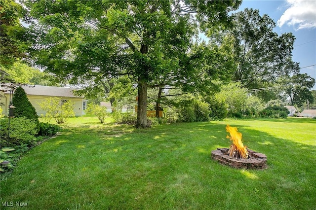 8298 Walter St NW, Massillon, OH 44646 - view of grassy yard with an outdoor fire pit