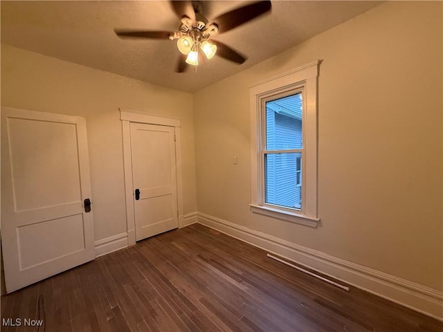 2000 16th St, Parkersburg, WV 26101 - unfurnished bedroom featuring dark wood-type flooring, ceiling fan, and a closet