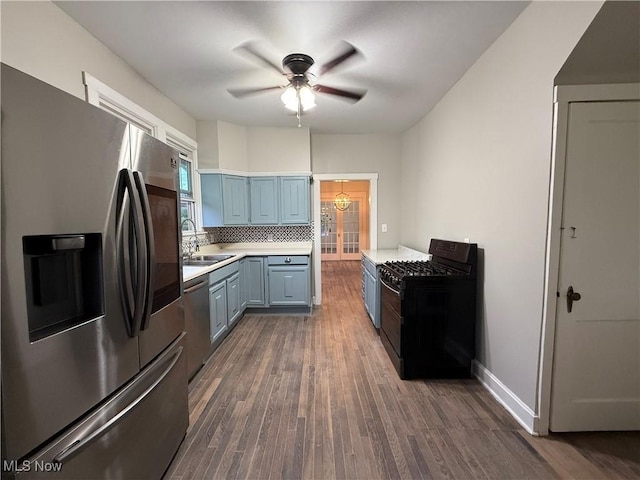 2000 16th St, Parkersburg, WV 26101 - kitchen featuring appliances with stainless steel finishes, a ceiling fan, light countertops, dark wood-style flooring, and tasteful backsplash