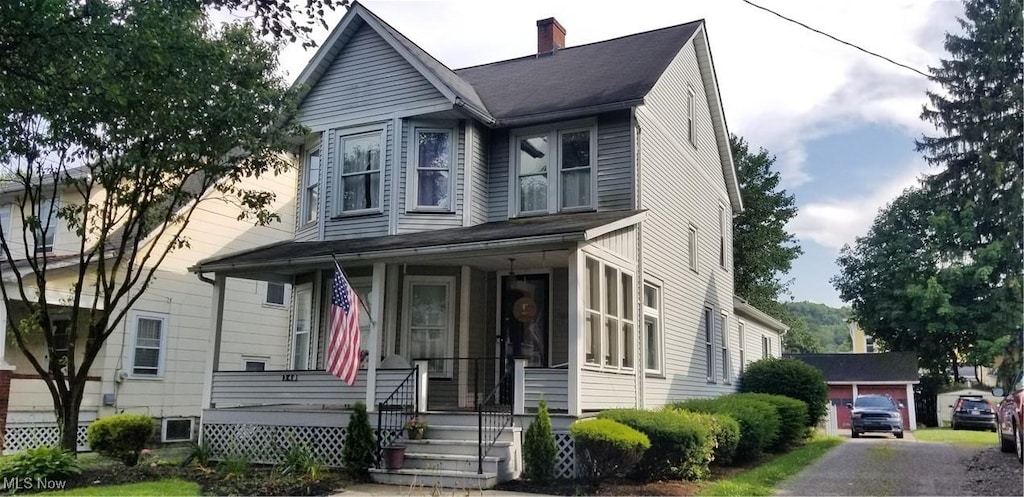 340 E Chestnut St, Lisbon, OH 44432 - view of front facade featuring a porch and a chimney