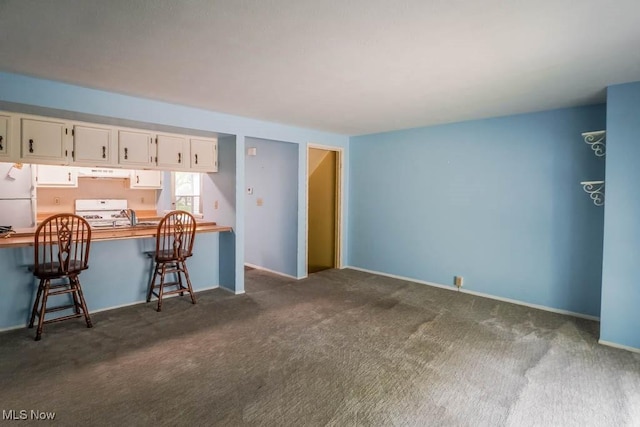 3888 Lake Run Blvd, Stow, OH 44224 - kitchen with white appliances, under cabinet range hood, dark carpet, white cabinets, and a desk