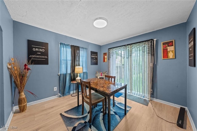 782 Ardella Ave, Akron, OH 44306 - dining area featuring light wood-style flooring and a textured ceiling