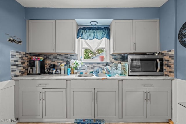 782 Ardella Ave, Akron, OH 44306 - kitchen featuring stainless steel microwave, light countertops, and backsplash