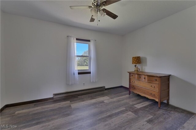 6414 Elk Rd, Canfield, OH 44406 - empty room featuring a baseboard heating unit, wood finished floors, and a ceiling fan