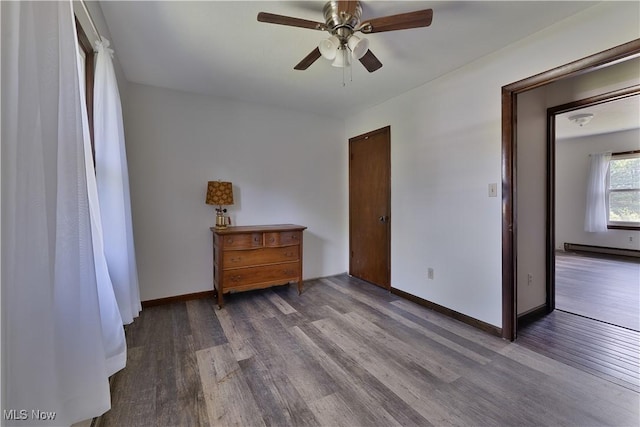 6414 Elk Rd, Canfield, OH 44406 - bedroom with wood finished floors, baseboard heating, and a ceiling fan