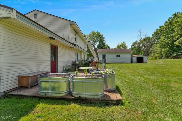 6414 Elk Rd, Canfield, OH 44406 - view of grassy yard featuring a storage unit and a wooden deck