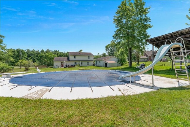 6414 Elk Rd, Canfield, OH 44406 - view of pool with a water slide, a diving board, a yard, a covered pool, and a patio area