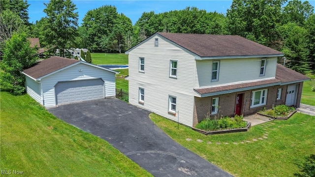 6414 Elk Rd, Canfield, OH 44406 - traditional-style home featuring an outbuilding, a detached garage, a front lawn, and a shingled roof