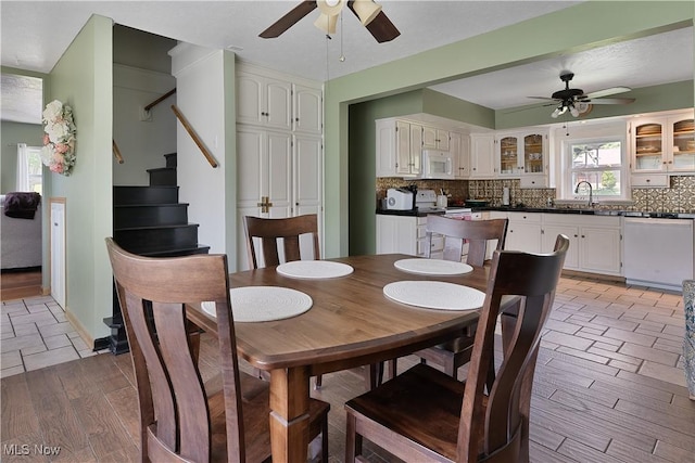 6414 Elk Rd, Canfield, OH 44406 - dining area with ceiling fan, light wood finished floors, and stairway