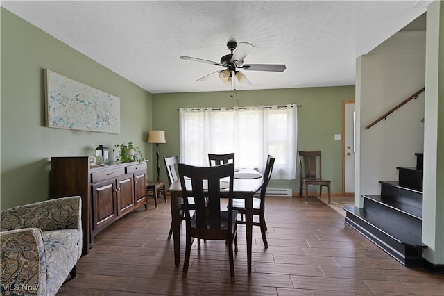 6414 Elk Rd, Canfield, OH 44406 - dining space with ceiling fan, stairway, wood finish floors, baseboard heating, and a textured ceiling
