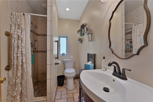 6414 Elk Rd, Canfield, OH 44406 - bathroom featuring tiled shower, vanity, and tile patterned floors