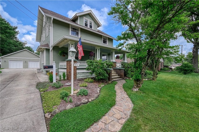 312 S Cleveland Ave, Mogadore, OH 44260 - traditional style home featuring an outdoor structure, a garage, covered porch, and a front lawn