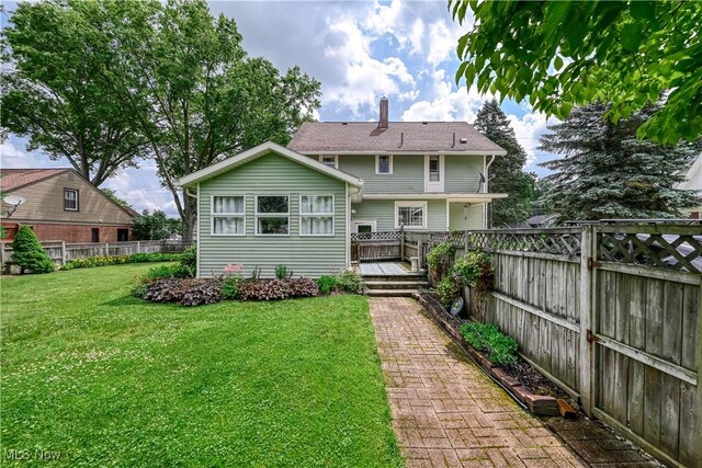312 S Cleveland Ave, Mogadore, OH 44260 - back of property featuring a deck and a chimney