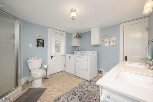 312 S Cleveland Ave, Mogadore, OH 44260 - full bathroom featuring independent washer and dryer, a shower stall, and double vanity