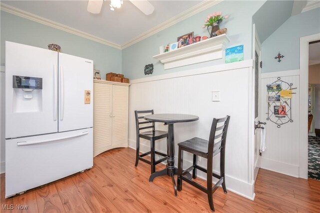 312 S Cleveland Ave, Mogadore, OH 44260 - dining area featuring wood finished floors, a wainscoted wall, ornamental molding, and ceiling fan