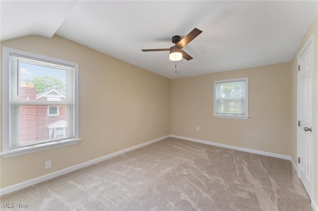 2413 W Manor Ave, Struthers, OH 44514 - unfurnished bedroom featuring light colored carpet, multiple windows, vaulted ceiling, and ceiling fan
