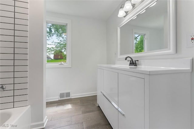 2413 W Manor Ave, Struthers, OH 44514 - bathroom featuring vanity, wood finished floors, and bathtub / shower combination